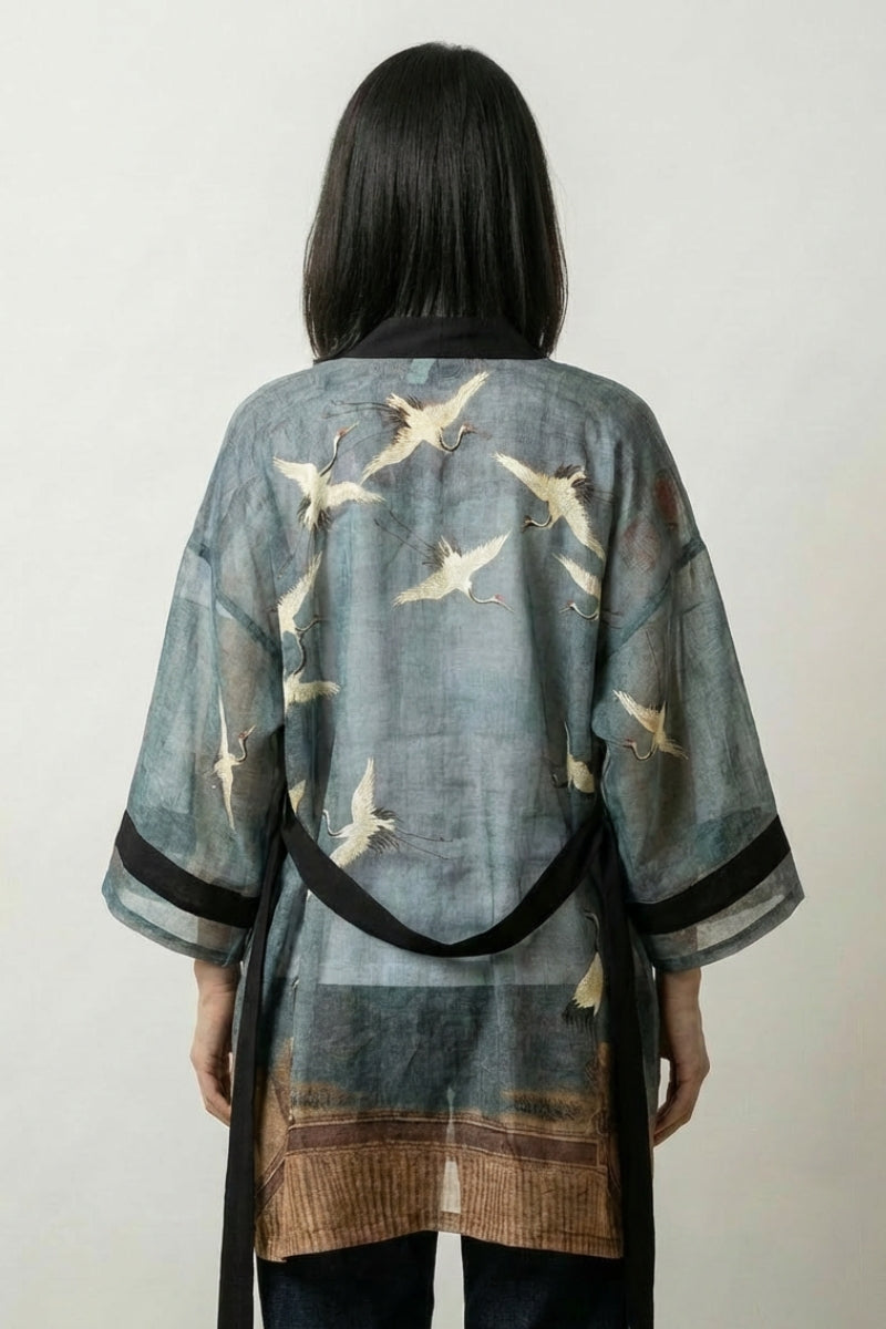 Kimono robe Amaya in faded sea-green, thigh-length with white cranes in flight, black borders and a tie belt at the waist