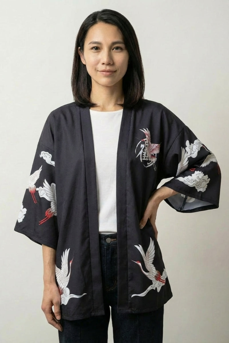 Kimono jacket Haruko in black, front view: open satin-finish jacket with three-quarter sleeves and scattered pale cranes