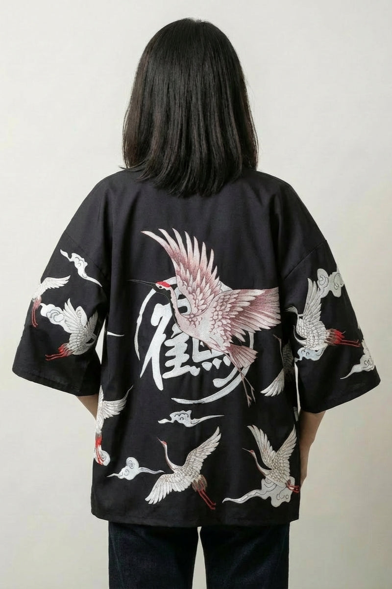 Back view of the black Haruko kimono jacket: a crimson bird with flared wings around a calligraphic seal set in a circle