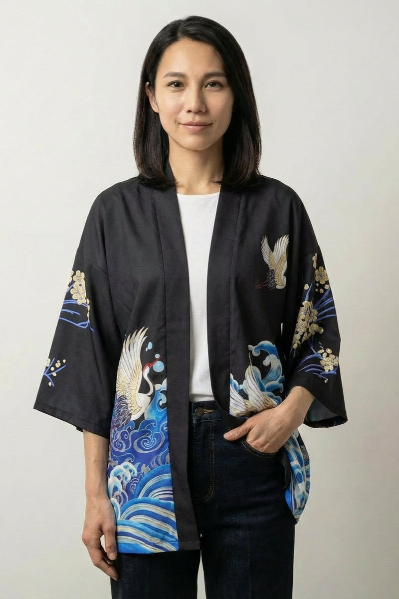 Kimono jacket Sanaé in black, front view: blue and gold wave print on an open three-quarter sleeve jacket