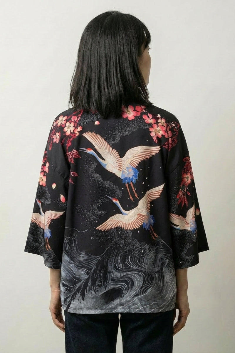 Back view of the Harumi kimono top: cranes wheeling in flight above a swirling grey whirlpool that spirals down to the hem