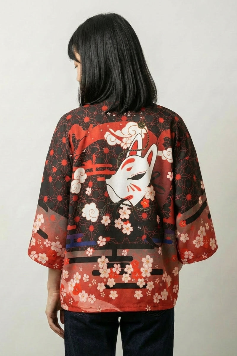 Back view of the kitsune kimono: a white fox seated among red plum blossom beneath a torii gate against a black and crimson sky