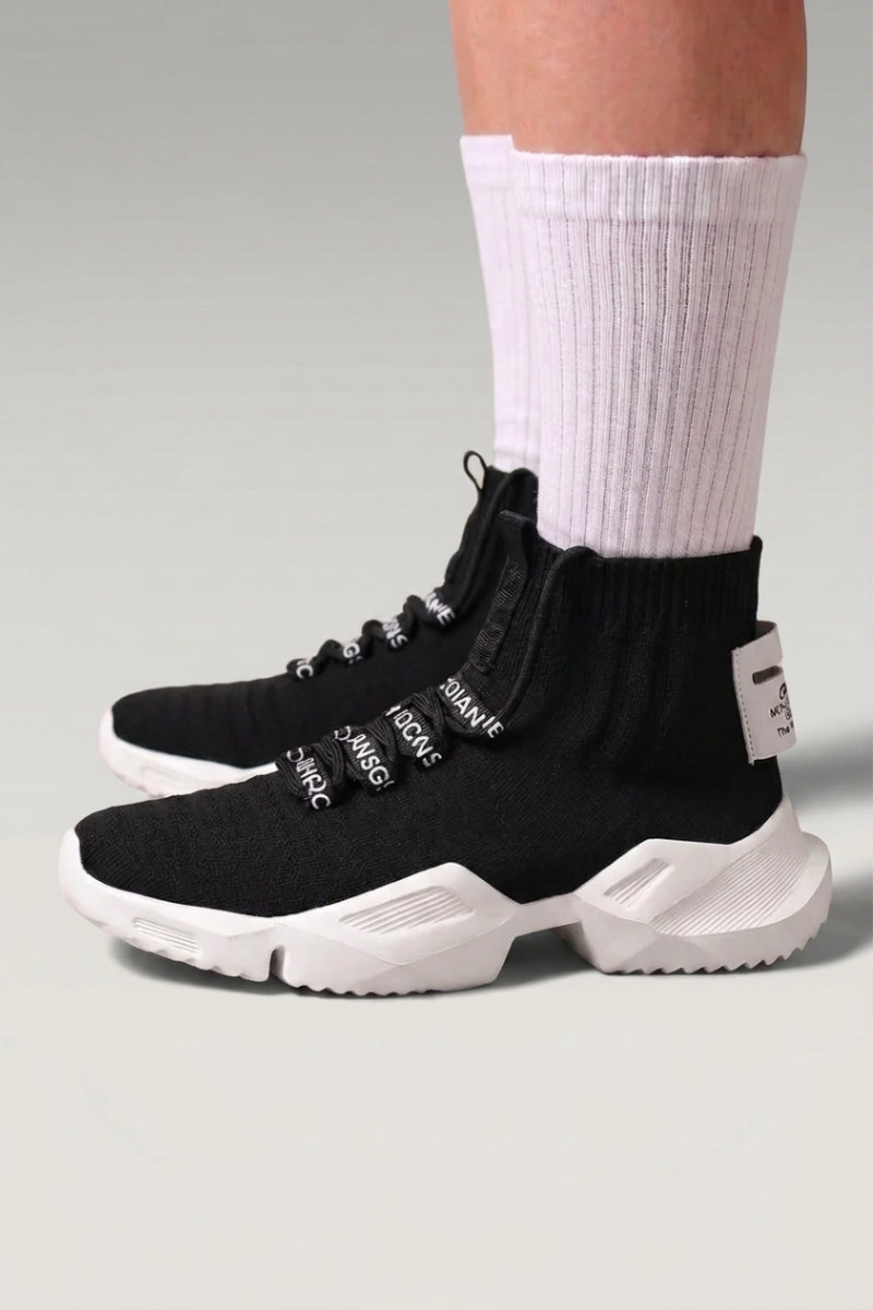 Black Japanese high-top sneakers 'Kashiwa', worn on foot with white socks — Japanese streetwear style