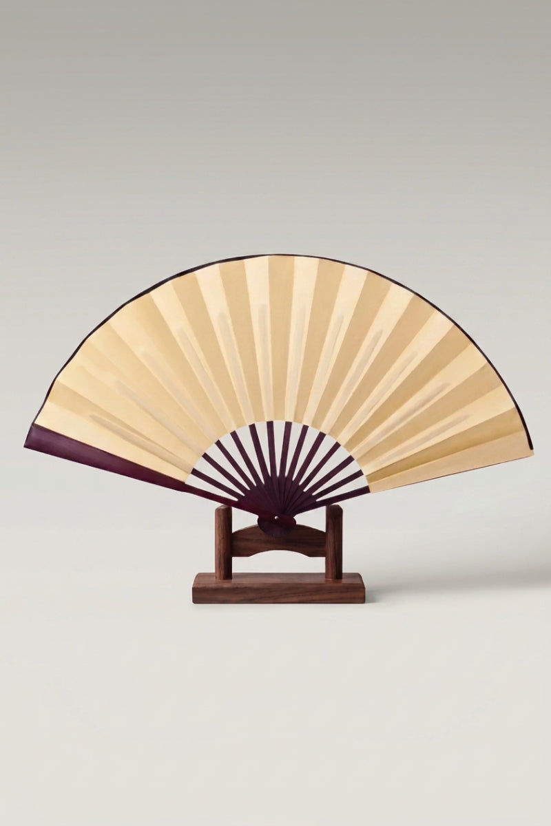 Large Japanese folding fan 'Kisho' — an oversized plain gold leaf on a large bamboo folding fan, shown open on a wooden stand