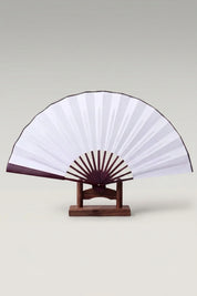 Large Japanese folding fan 'Kisho' — an oversized plain white leaf on a large bamboo folding fan, shown open on a wooden stand