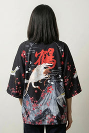 Back view of the black Edo kimono jacket, the crimson blossom and crane reading loud against black