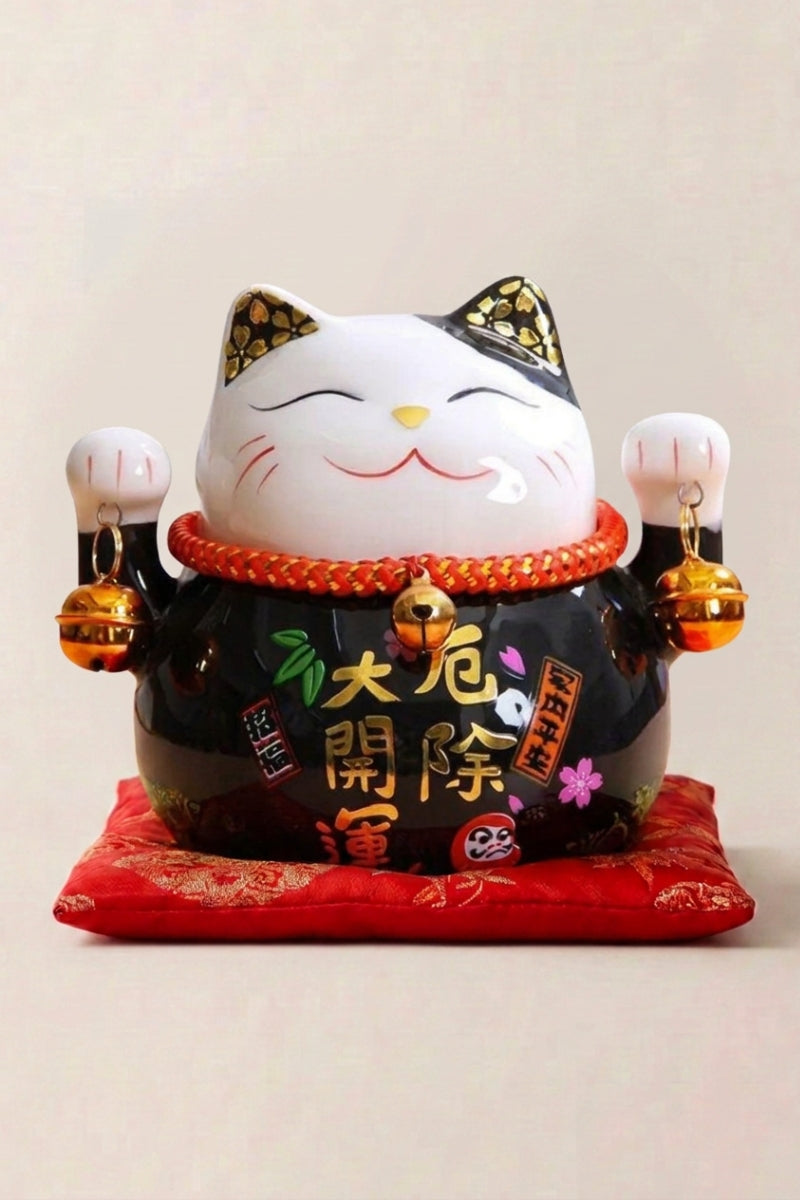 Maneki Neko Money Box 'Black' — Japanese maneki-neko lucky cat money box, black ceramic lucky cat with gold calligraphy and bells on a red cushion