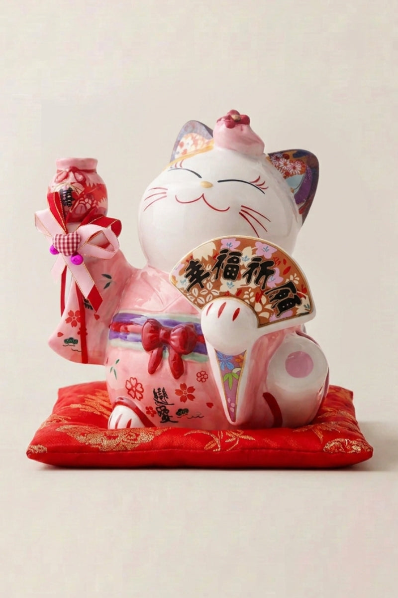Maneki Neko Money Box 'Pink Fortune' — Japanese maneki-neko lucky cat money box, white ceramic lucky cat holding a fan beside a pink temple gate on a red cushion