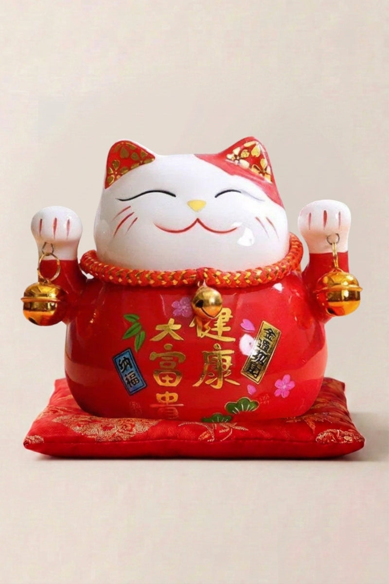 Maneki Neko Money Box 'Red' — Japanese maneki-neko lucky cat money box, red-and-white ceramic lucky cat with gold bells and kanji on a red cushion