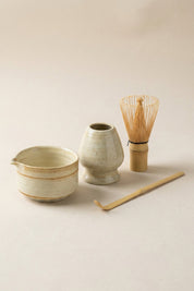 Japanese matcha set in white speckled ceramic: spouted chawan bowl, whisk stand, bamboo chasen whisk and bamboo chashaku scoop