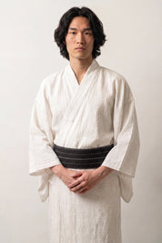 Deep navy obi belt ruled with crisp white stripes, worn over a white kimono