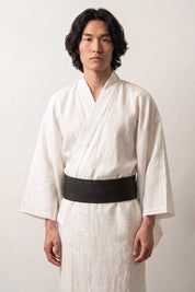 Black obi belt woven with dense fine gray striations, worn over a white kimono