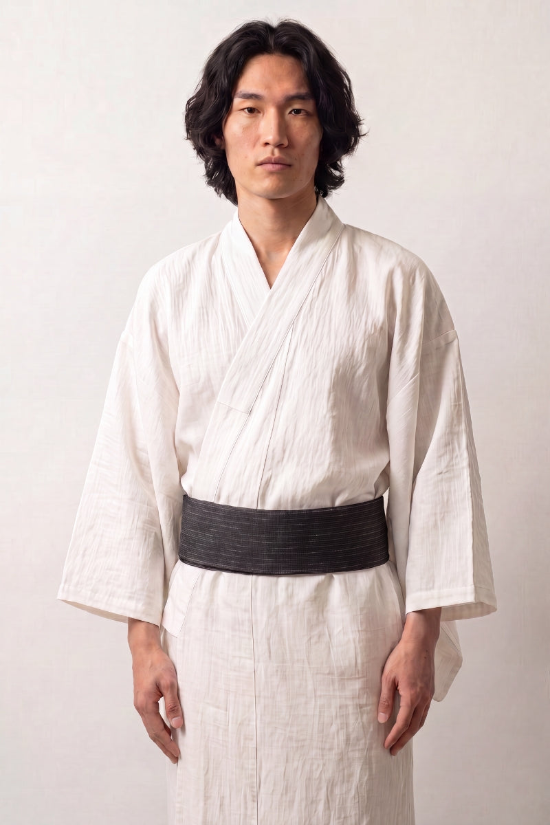Dark teal obi belt with fine gray vertical striations, worn over a white kimono