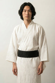 Solid black obi belt worn over a white linen kimono, thick woven fabric with a pre-formed front knot