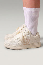White minimalist Japanese sneakers 'Yuki', worn on foot with white socks — Japanese streetwear style