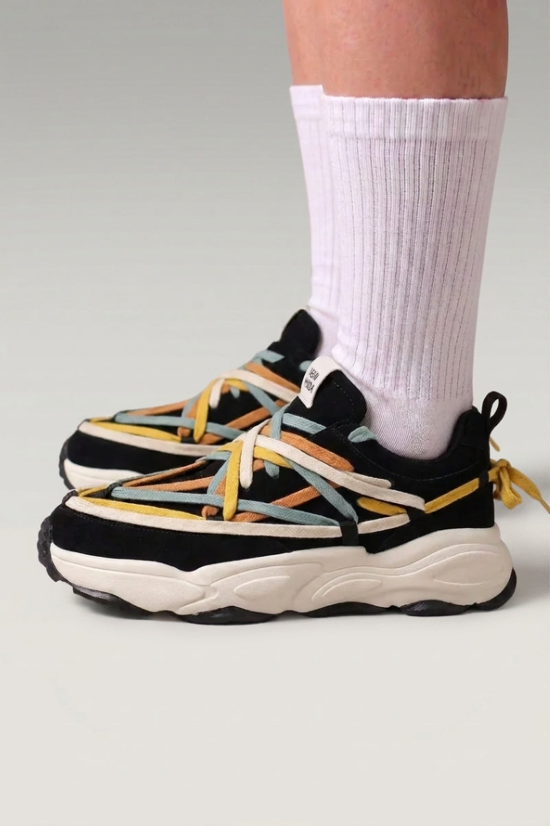 Black Japanese-made-style sneakers 'Fujioka', worn on foot with white socks — Japanese streetwear style