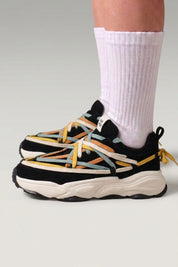 Black Japanese-made-style sneakers 'Fujioka', worn on foot with white socks — Japanese streetwear style