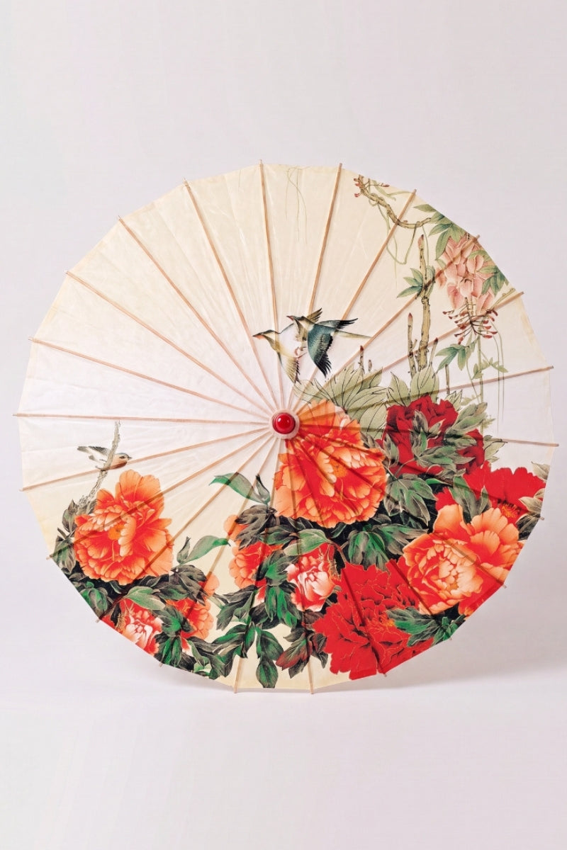 Traditional Japanese paper umbrella with orange and red peonies with a pair of birds on a cream-to-ivory ground, shown open on bamboo ribs