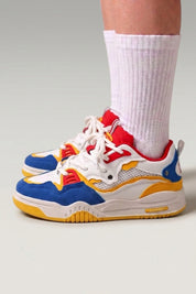 Yellow Japanese sport sneakers 'Raijin', worn on foot with white socks — Japanese streetwear style
