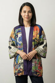 Skull kimono Zugaikotsu, front view: open kimono jacket with deep violet bands framing the front opening and a floral peacock print