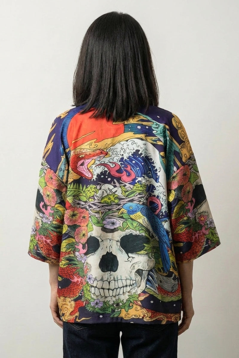 Back view of the Zugaikotsu skull kimono: a skull resolving out of peonies, bright blooms and peacock eye-feathers in full colour