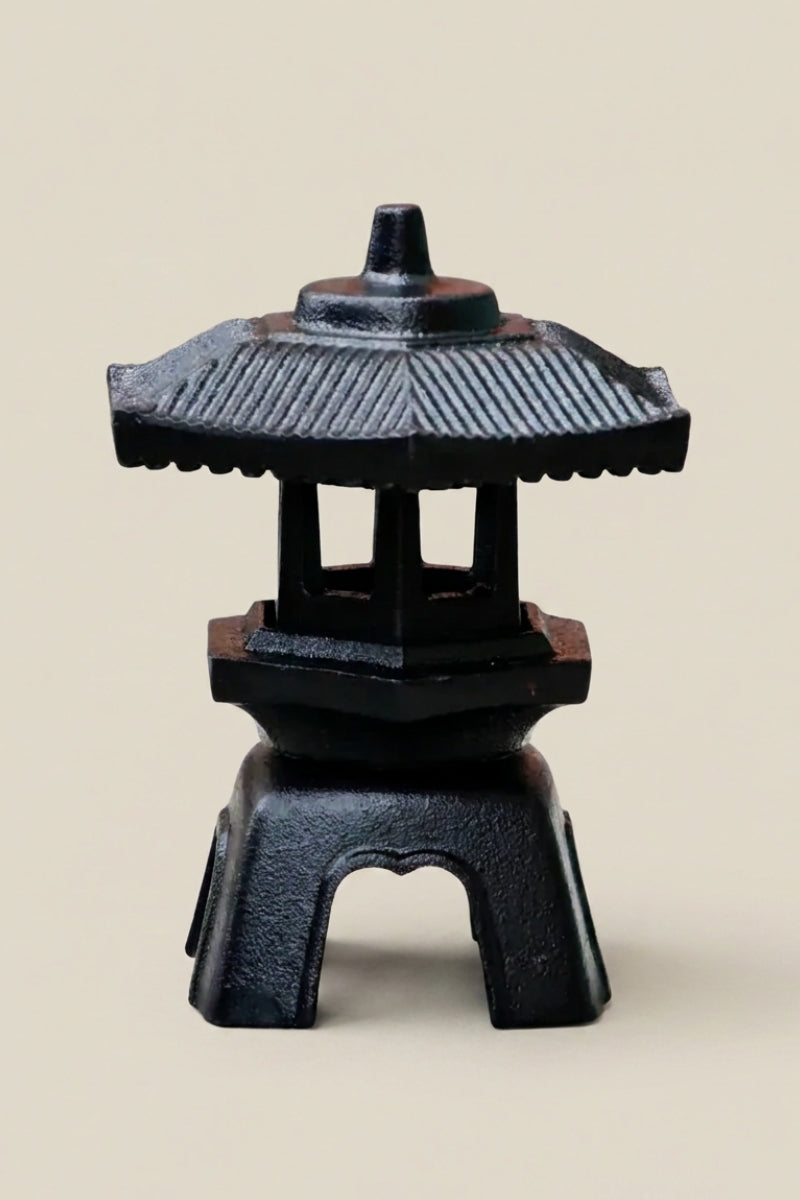 Small Japanese cast iron lantern — Japanese stone garden lantern, a small black cast-iron garden lantern with a tiered pagoda roof