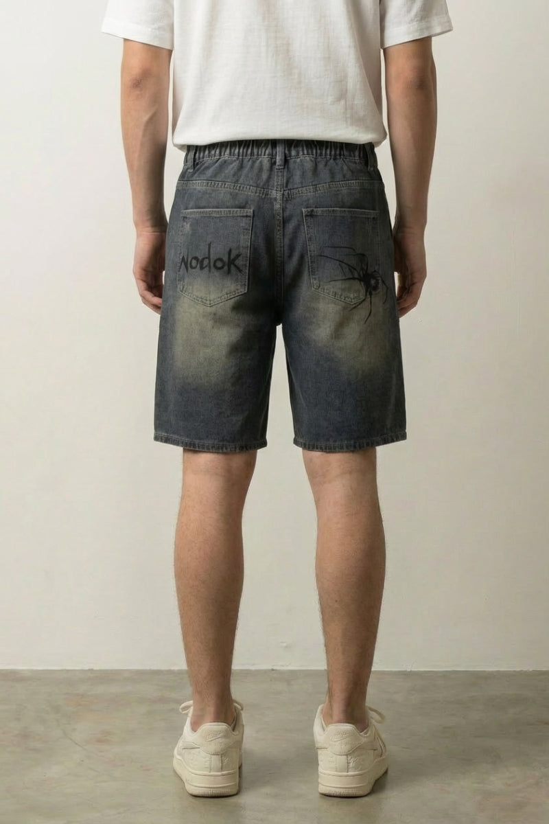 Y2K spider web graphic denim shorts styled look