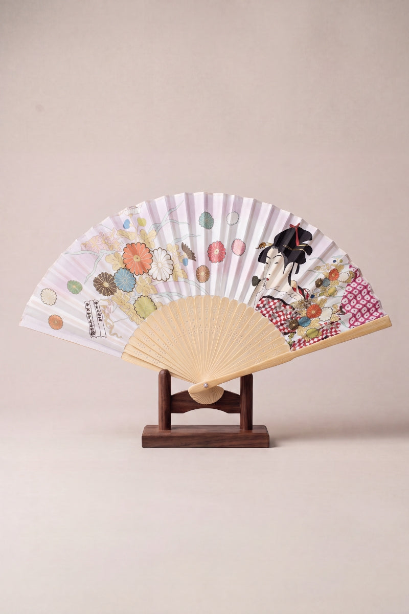 Japanese folding fan with an ukiyo-e geisha and chrysanthemums on a lilac-white leaf, on bamboo ribs