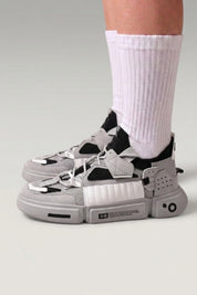 Black Japanese fashion sneakers 'Kazuno', worn on foot with white socks — Japanese streetwear style