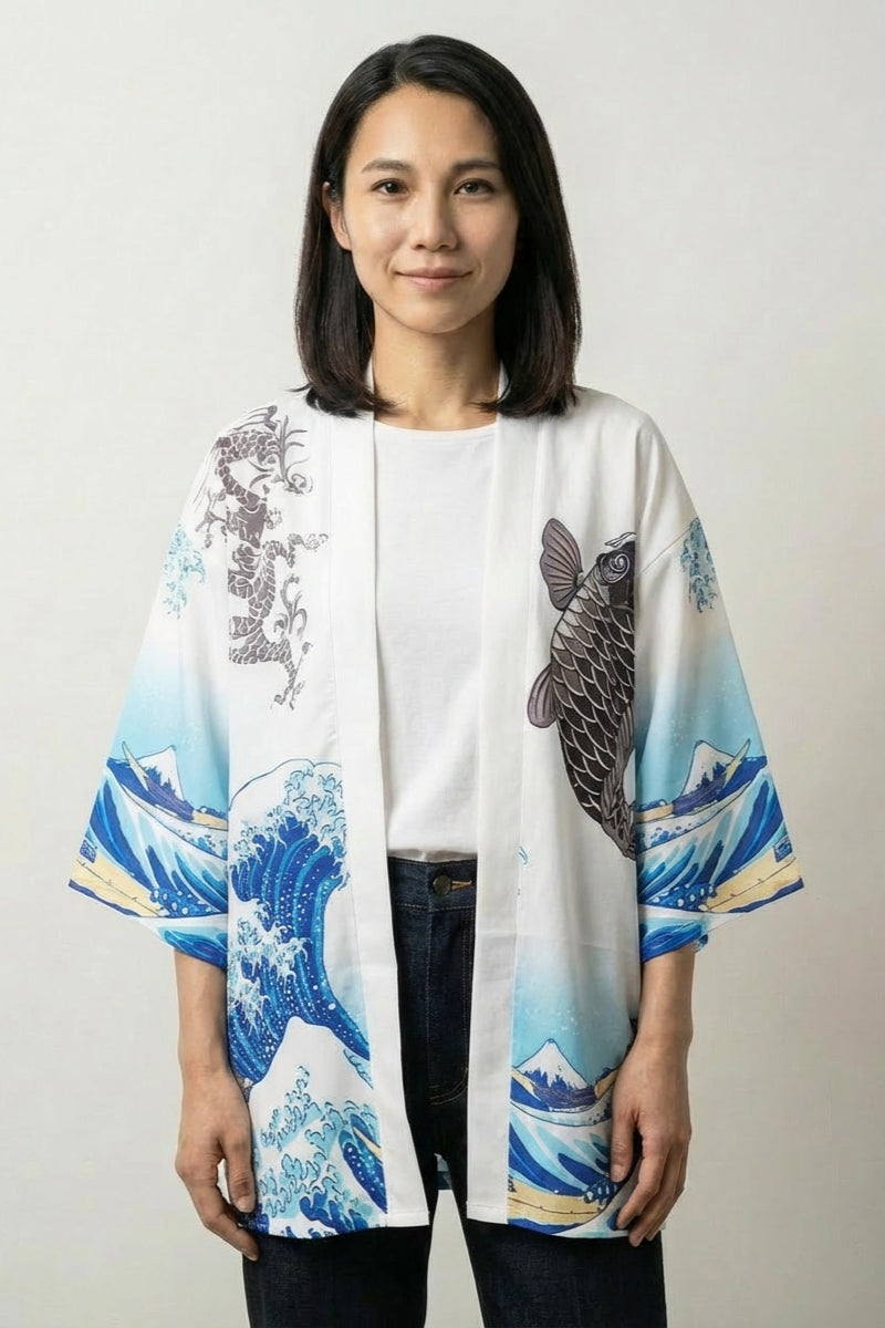 Women's kimono blouse Kanagawa in white, front view: a black koi carp rides Hokusai's great wave in blue and white across the open front and three-quarter sleeves