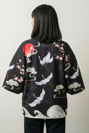 Back view of the Osaka kimono jacket: white cranes gliding beneath a red rising sun among soft clouds and pale plum blossom on deep black