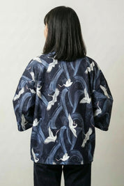 Back view of the Shikuru navy kimono: cranes and rolling waves printed tone-on-tone so the birds emerge from the water up close