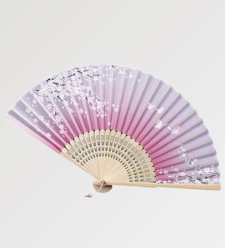 A Japanese fan with a cherry blossom design made of authentic wood