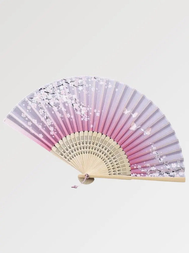 A Japanese fan with a cherry blossom design made of authentic wood