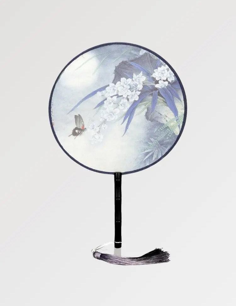 A round Japanese fan with a flowery pattern and pastel colors