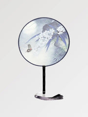 A round Japanese fan with a flowery pattern and pastel colors