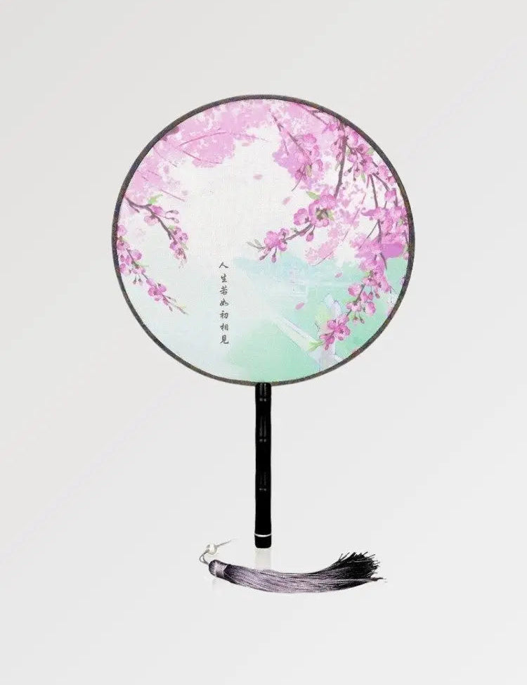 Traditional round Japanese fan with sakura pattern and Japanese calligraphy