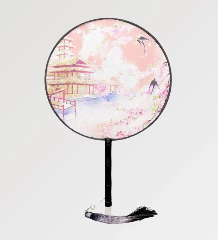 A round Japanese fan with a traditional temple design