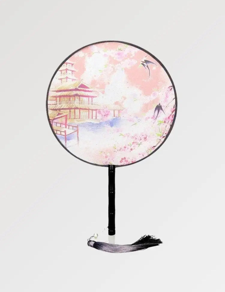 A round Japanese fan with a traditional temple design