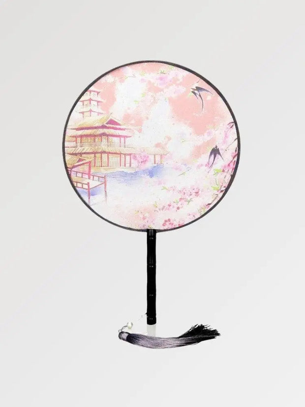 A round Japanese fan with a traditional temple design