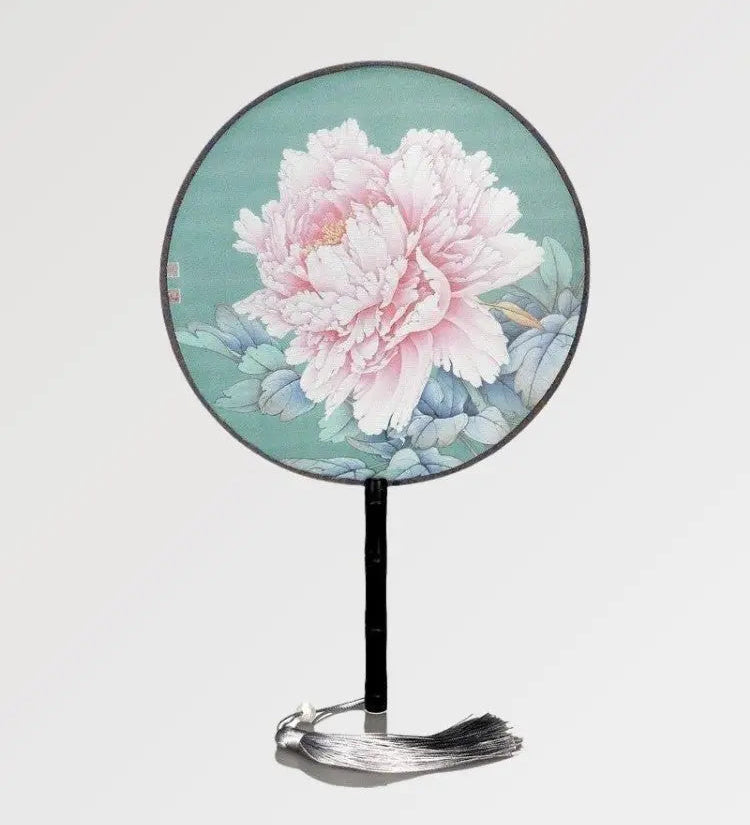 A round Japanese fan with a vintage design made of bamboo wood and a rose flower pattern