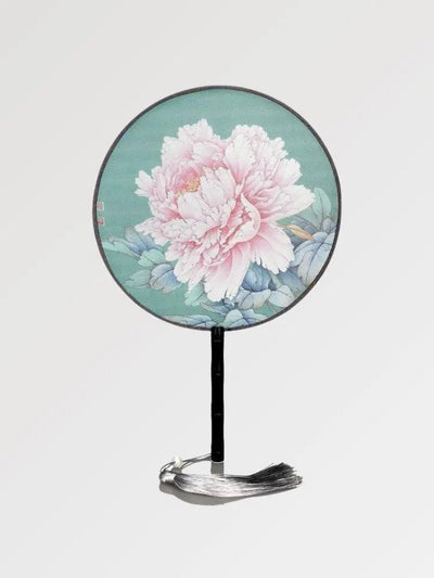 A round Japanese fan with a vintage design made of bamboo wood and a rose flower pattern