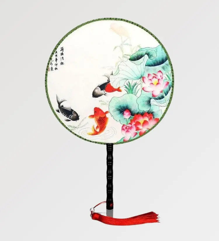 Japanese fan with round shape and fish and plants pattern