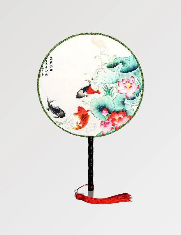 Japanese fan with round shape and fish and plants pattern