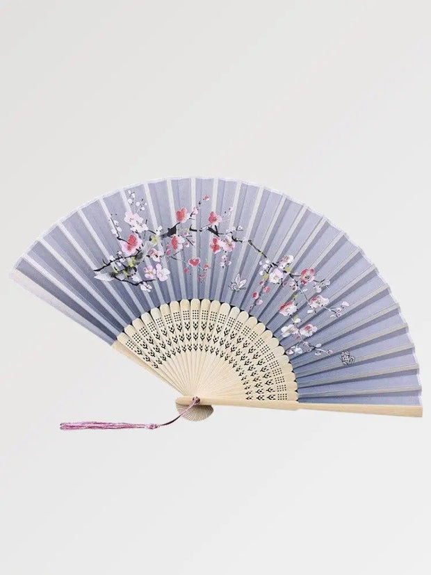 Beautiful wooden fan decorated with cherry blossoms in a soft color