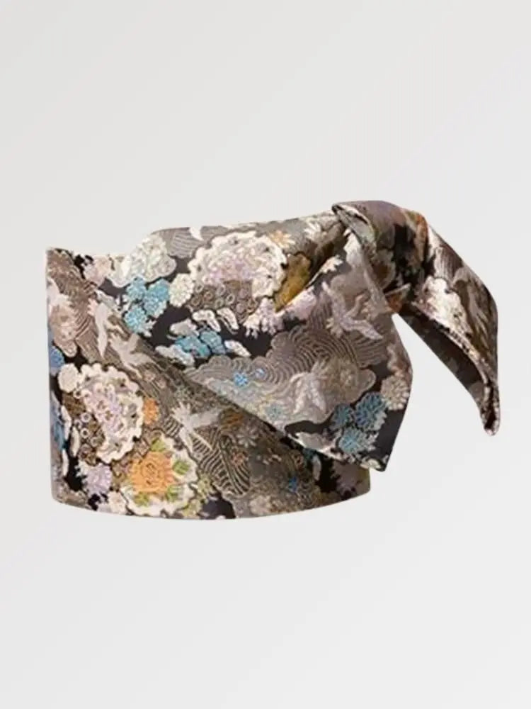 Black brocade obi belt with silver chrysanthemums, cranes and waves in blue, green and orange, flat product view showing the full sash and knot