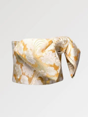 Soft gold obi belt woven with white blossom clusters and flowing-water lines, flat product view showing the full sash and knot