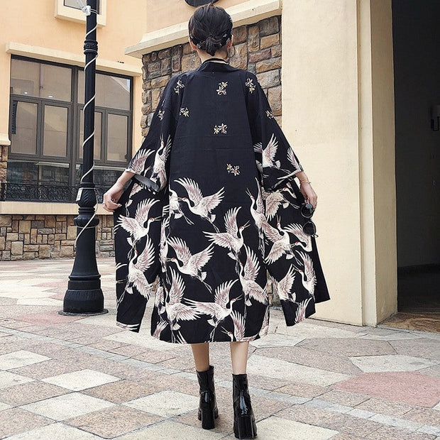 A long kimonos for women with a light fabric and a crane pattern
