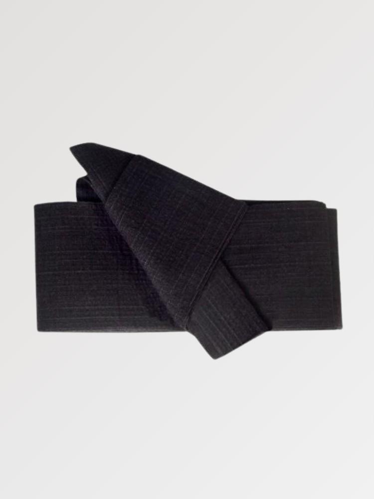 Solid black obi belt in thick woven fabric with a pre-formed front knot, flat product view showing the full sash and knot