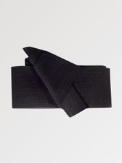 Solid black obi belt in thick woven fabric with a pre-formed front knot, flat product view showing the full sash and knot